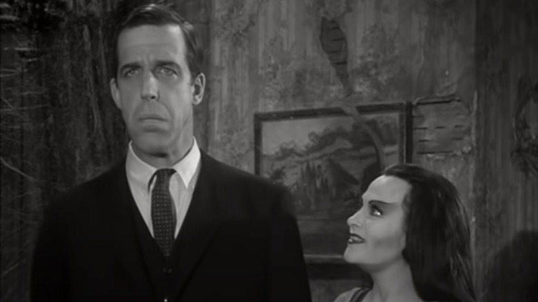 Herman and Lily Munster standing