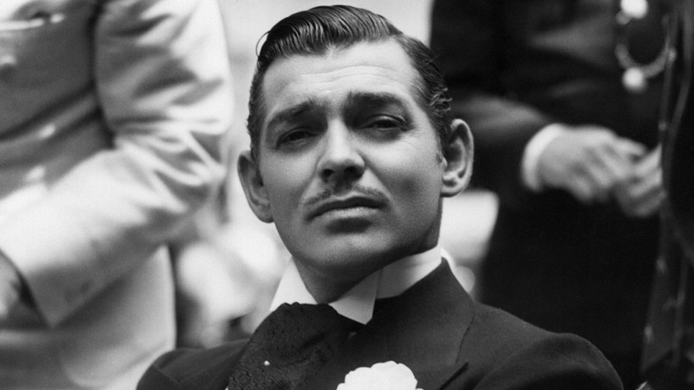 Clark Gable seated and posing