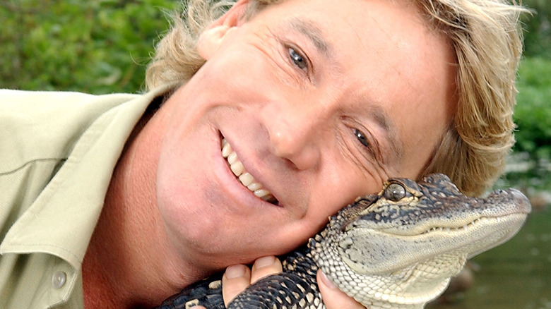 Steve Irwin snuggling with a cuddly croc
