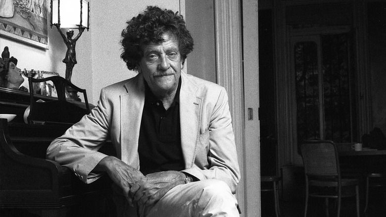 Kurt Vonnegut sitting and posing for a photo