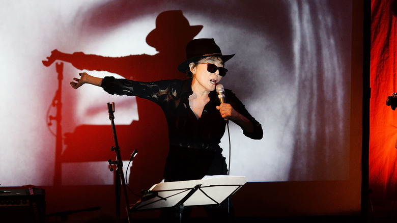 Yoko Ono on stage with mic