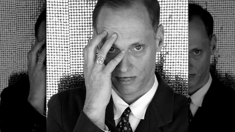 John Waters hand on face black and white