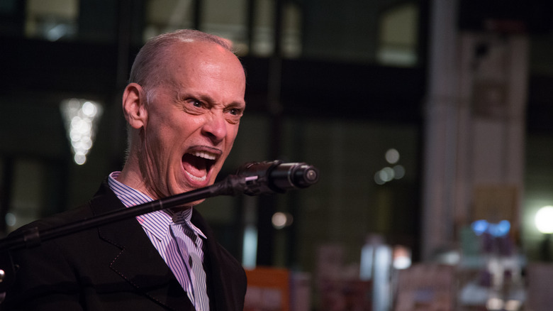 John Waters shouting into mic