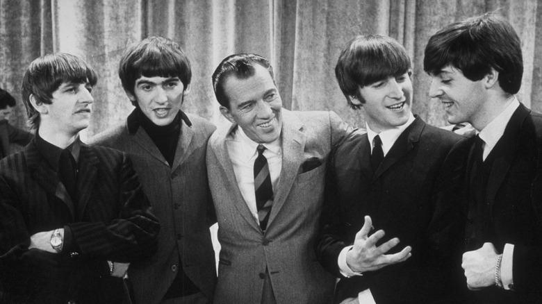 Ed Sullivan posing with the Beatles