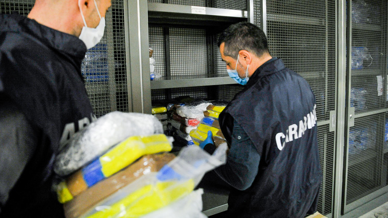 Police carry bricks of cocaine