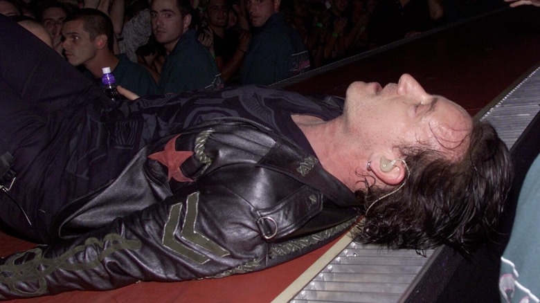 Bono lying on stage