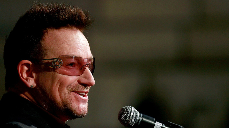 Bono smiling with mic