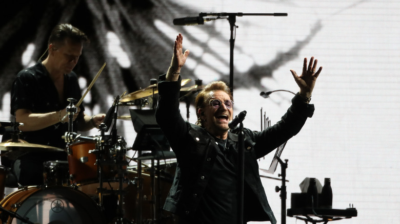 Bono on stage hands raised