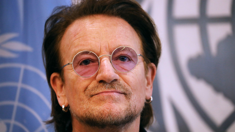 Bono in pink round glasses