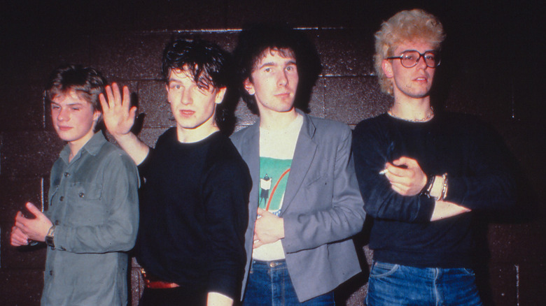 U2 in their early days in front of a wall