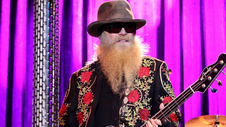 Dusty Hill holding bass guitar