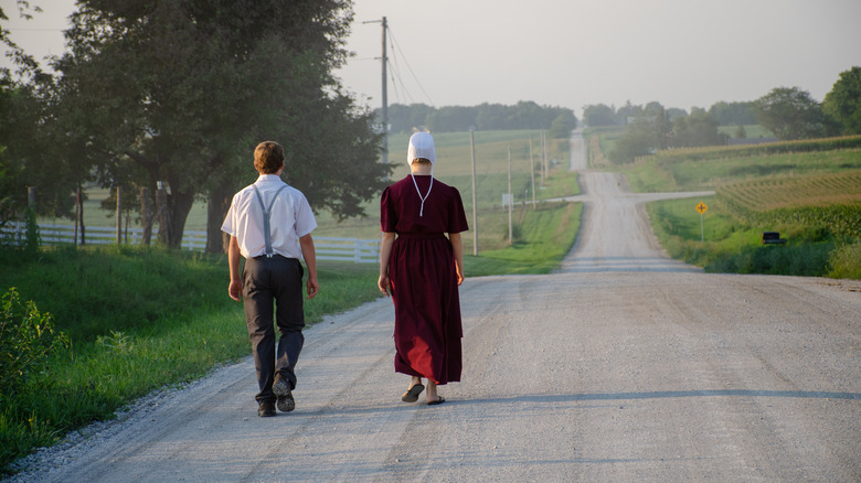 Amish man and woman walking down road