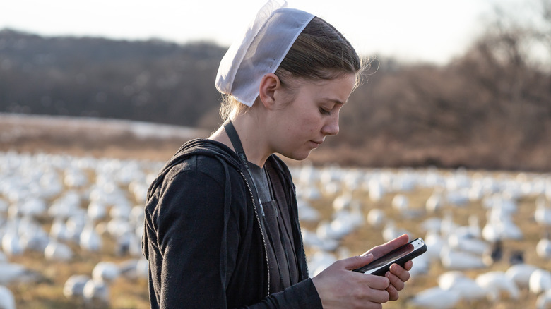 Amish girl using cell phone