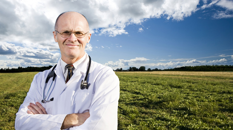 Doctor standing in a field