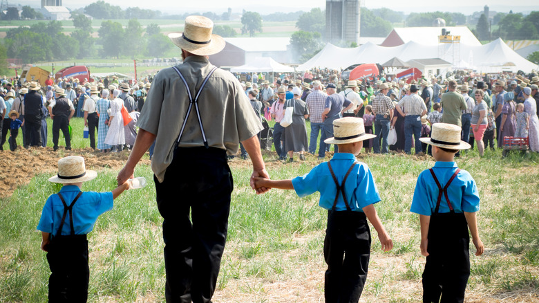 Amish man walking with his children