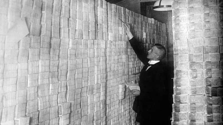 man counting stacks of marks