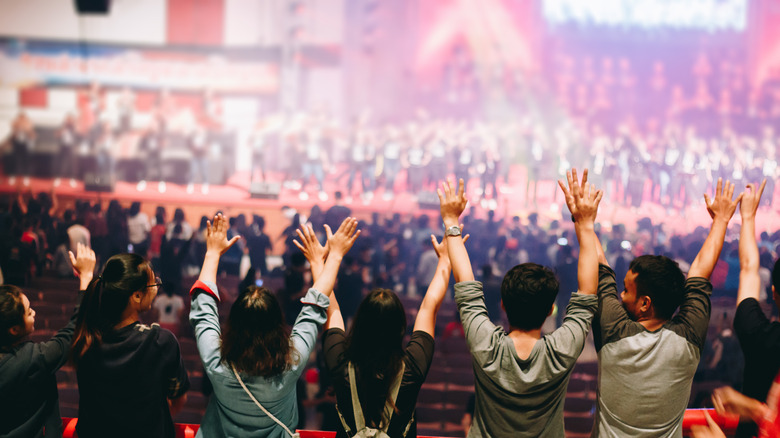 Christians worshipping with raised hands