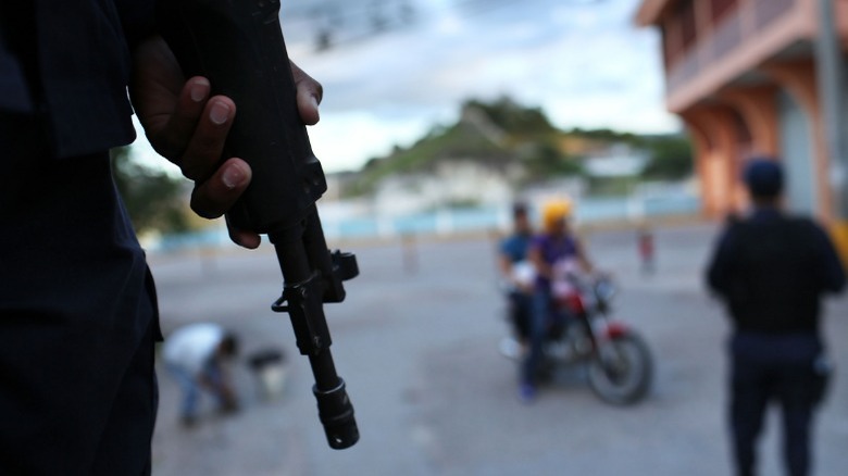 Honduras police holding gun