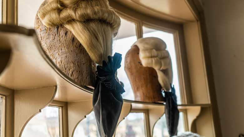 men's wigs in shop window