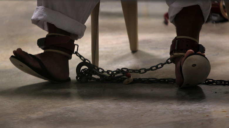 Guantanamo Bay inmate in shackles