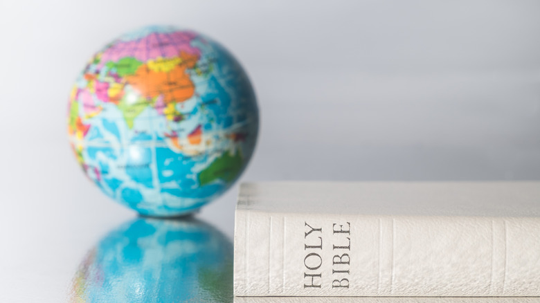 A globe with a Bible