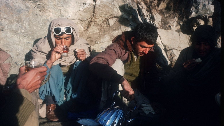 Mujahideen fighters drinking outside