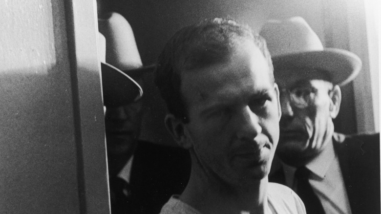 Lee Harvey Oswald being escorted through police interviews