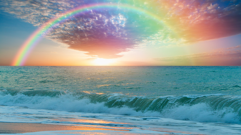Rainbow over ocean horizon