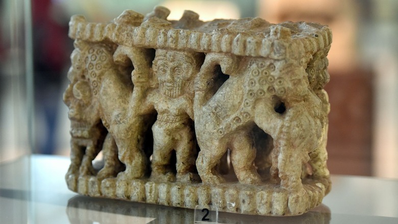 Sculptured vase. This stone piece is carved with a scene depicting Gilgamesh wrestling two bulls.