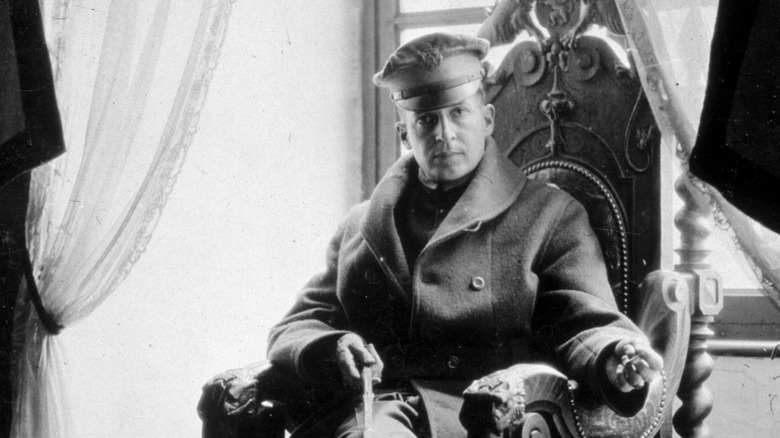 General MacArthur sitting in a throne-like chair