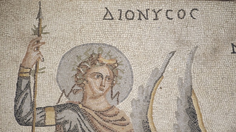 Dionysus holds a thyrsos