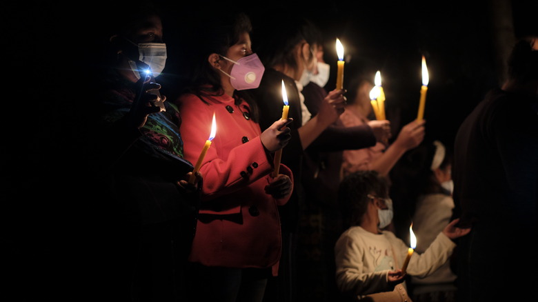 Guatemalans light candles during vigil