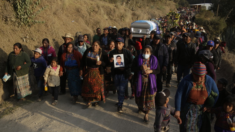 people carry a coffin