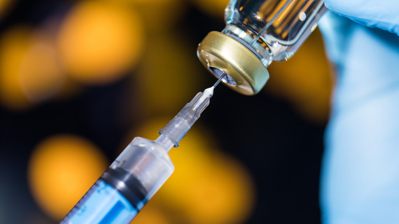 Syringe being filled with vaccine
