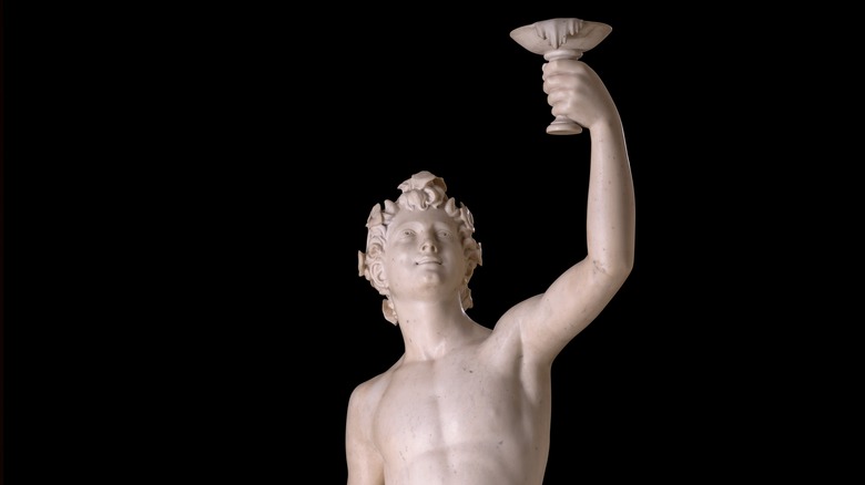 Statue of Dionysus raising wine glass