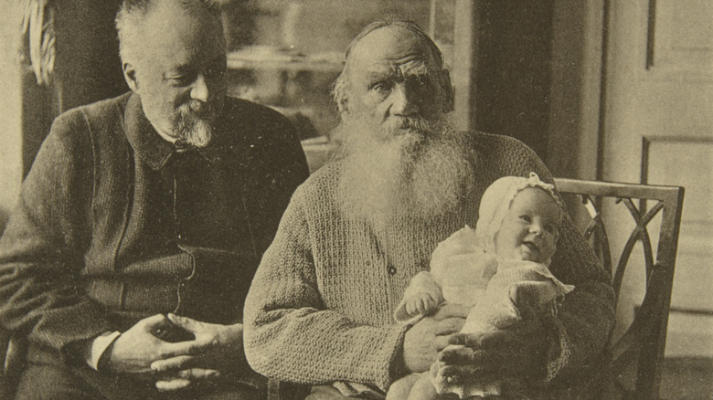 Leo Tolstoy holding a baby
