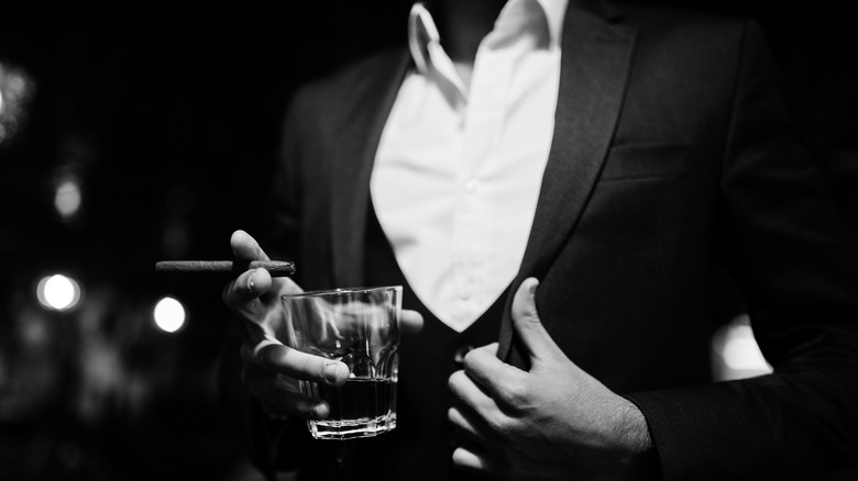 a man in a suit with a cocktail