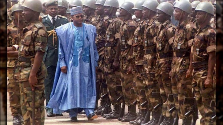 Sani Abacha walking in front of rows of soldiers