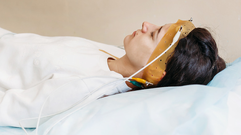 Woman with electrodes on head