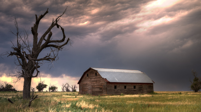 abandoned barn against dark sky
