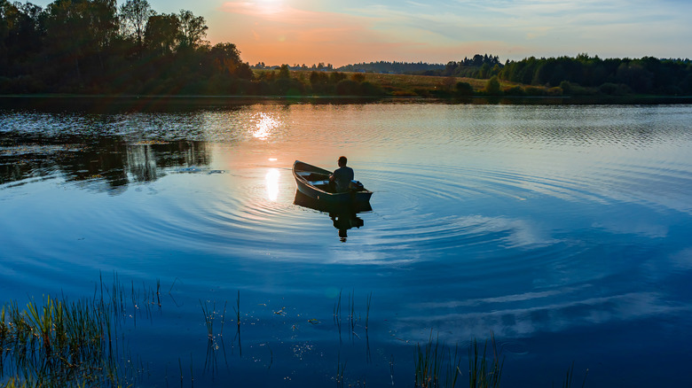 Man fishing on calm lake