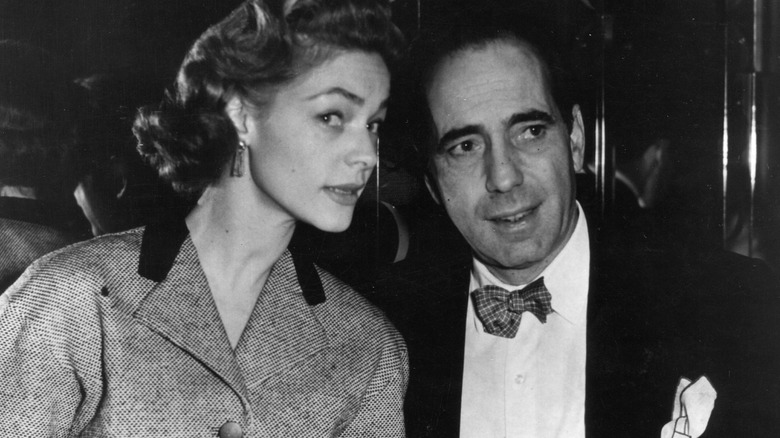 Lauren Bacall and Humphrey Bogart, seated and talking