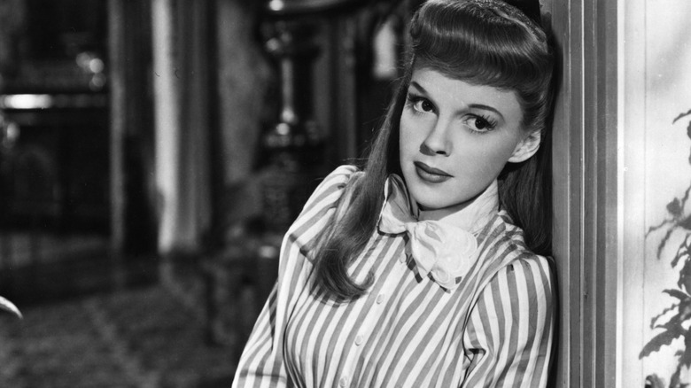 Judy Garland, seated and gazing