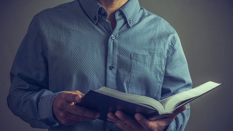Male pastor holding bible