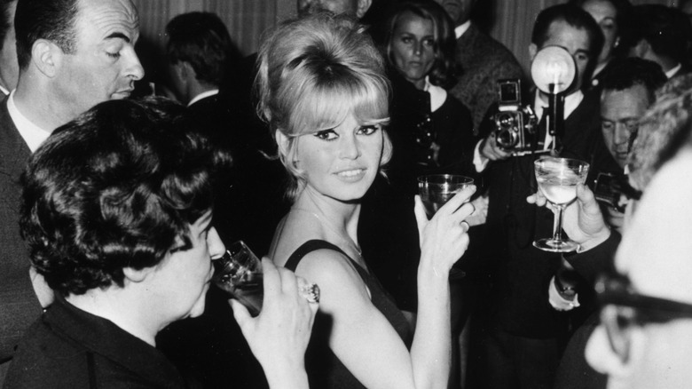 Brigitte Bardot raising a glass