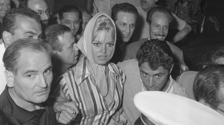 Brigitte Bardot surrounded by men