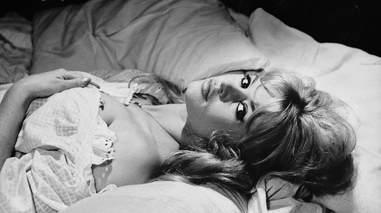 Brigitte Bardot laying and posing in bed