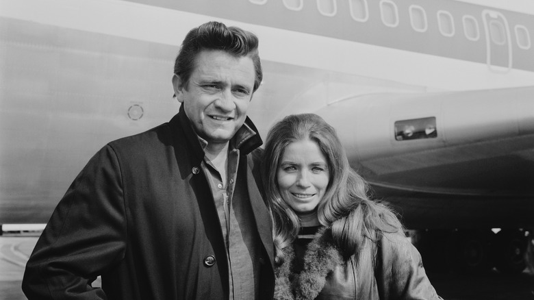 Johnny Cash and June Carter standing