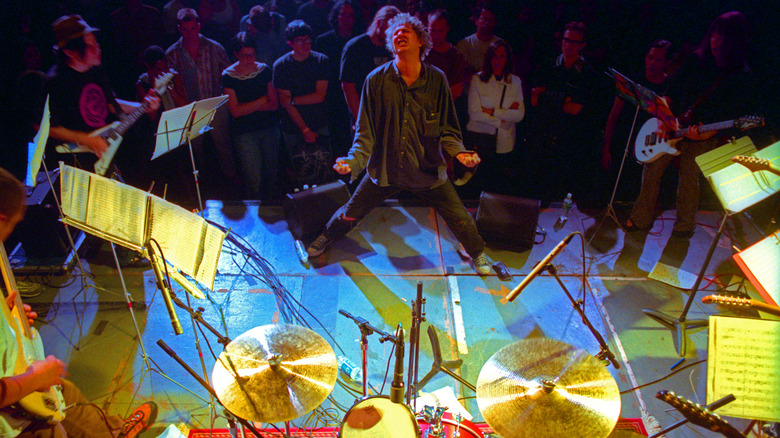 Glenn Branca on stage with Guitar Orchestra and Audience