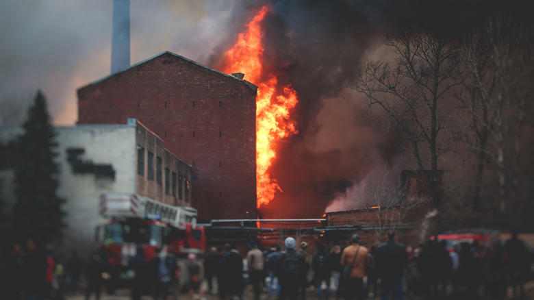 Crowd gathers around burning building